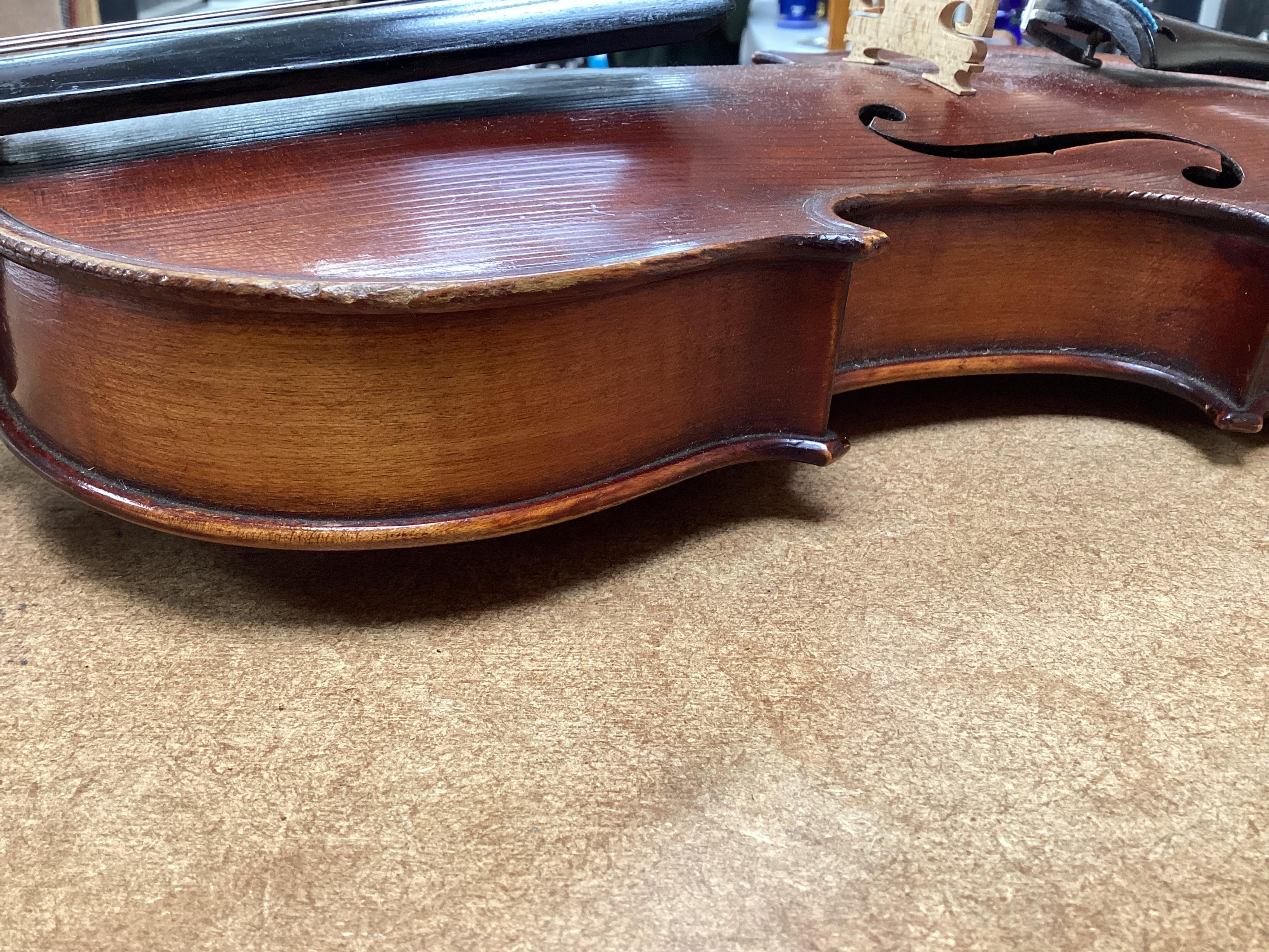 A cased late 19th century German Mittenwald violin with lion’s head scroll, and two bows, Ivory submission ref: RP2E5HT1